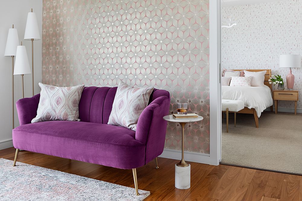 Feminine eclectic with thoughtful pink and purple color choices including a vintage sofa and gorgeous wallpaper.